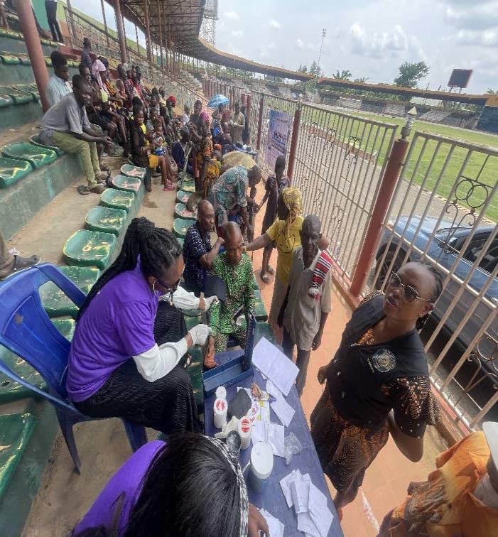 Medical consultation, BP check, and drug dispensing ongoing during the free medical outreach.